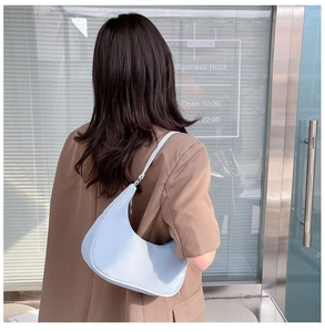 Close-up of a light blue nylon hobo bag on a shoulder for daily commute style