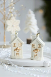 Set of two white and gold ceramic house ornaments displayed for Christmas tree decoration