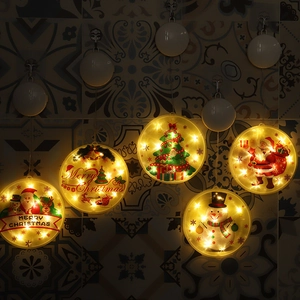 Close-up of warm white LED Christmas window suction lights with festive motifs