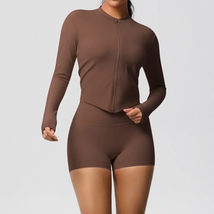 Detail of dark brown slim-fit sports set with full-zip long sleeve top and high waist shorts