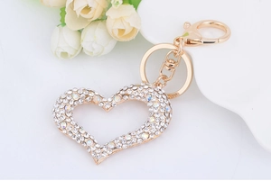 Macro shot of sparkling heart keychain with crystals and gold lobster clasp