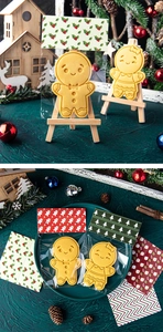 Gingerbread man cookies in festive packaging on a green plate with holiday decor
