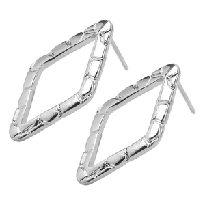 Close-up of geometric hollow diamond studs with bamboo texture in silver finish