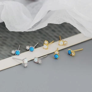 Detail showing gold and silver S925 stud earrings with blue and white opal stones