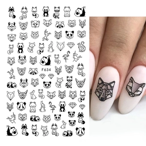 Macro shot of 3D geometric animal nail art stickers with black fox and panda patterns
