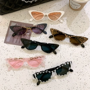 Stylish cat-eye sunglasses collection with metal chain temples on stone texture