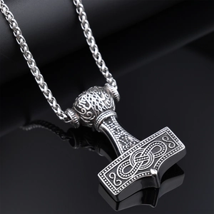 Macro shot of Viking Mjölnir pendant with compass pattern and textured steel finish