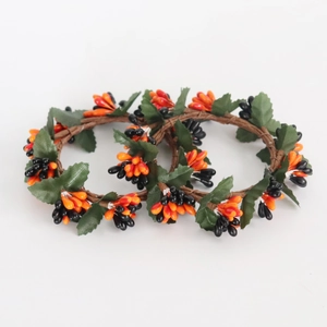 Orange and black berry candle rings with green leaves for Halloween harvest decor