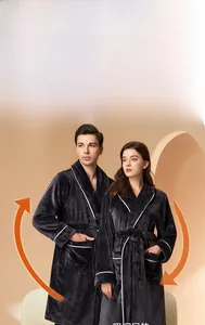 Detail of dark grey coral fleece robes featuring white piping and warm plush texture