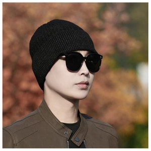 Detail of classic black ribbed knit beanie with soft texture and warm winter material