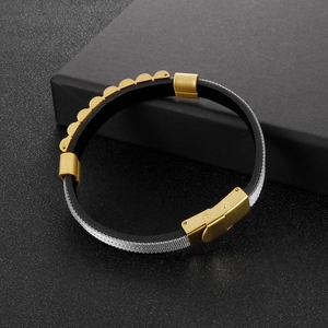 Macro view of men's leather bracelet with steel mesh strap and golden watch buckle