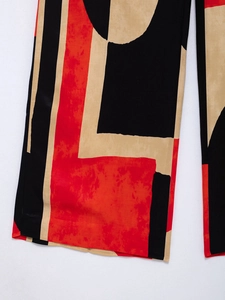 Detailed macro view of geometric print wide leg trousers with premium stitching and color blocks