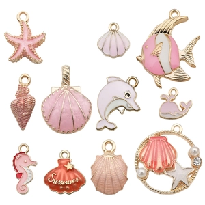 Pink and gold enamel ocean charms set with starfish, shell, and dolphin for DIY jewelry