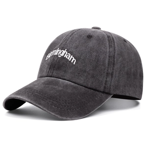 Detail view of white Birmingham embroidery on a vintage grey washed cotton baseball cap