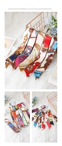 Detailed view of elegant narrow silk-feel scarves with vintage carriage and chain prints