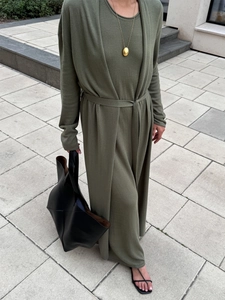 Detail of olive green knit cardigan and dress set with matching belt and black tote bag