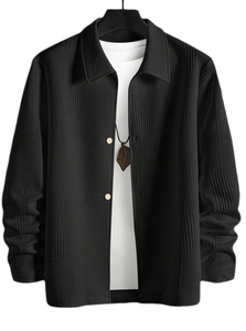 Detail of black geometric quilted jacket with spread collar and leaf pendant necklace
