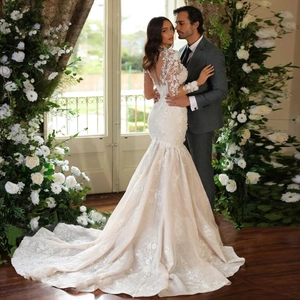 Elegant white lace mermaid wedding dress with long sleeves and cathedral train