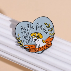 Heart-shaped enamel dog brooch with Be the person your dog thinks you are slogan