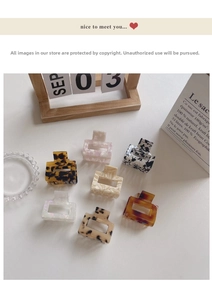 Flat lay of small square acetate hair claws in various marble and tortoise textures