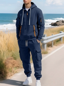 Detail view of navy blue hooded tracksuit with orange zippers and functional cargo pockets