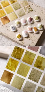 Detail of TK-010 nail art stickers featuring gold foil textures on pearl-accented nails