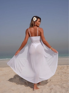 Elegant white mesh cover-up dress with large flowy skirt and matching bikini on beach