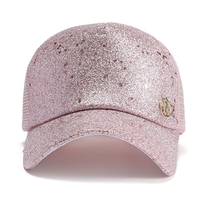 Detailed close-up of pink sequined baseball cap with side gold metal logo badge
