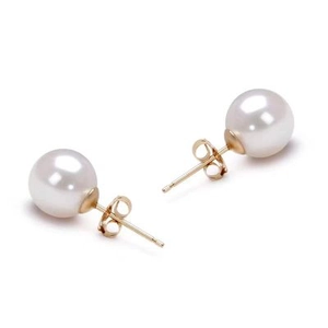 Detailed view of round white pearl stud earrings with classic 18K gold butterfly backings
