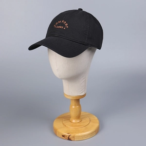 Classic black cotton baseball cap with orange Comfort Zones embroidery on head model