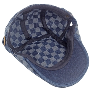Detail view of denim beret featuring 100% cotton label and checkerboard lining