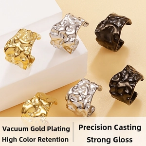 Detailed macro of irregular hammered texture earrings in gold, silver, and black finish