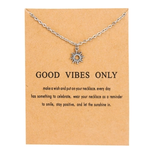 Silver sun pendant necklace on kraft card with Good Vibes Only inspirational text