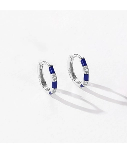 Macro shot of S925 sterling silver hoop earrings with blue enamel and sparkling zircons