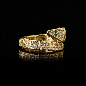Detail of snake ring in 18K gold plating with sparkling white and green zircon stones