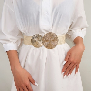 Detail view of women wide elastic woven belt with large gold metallic textured buckle