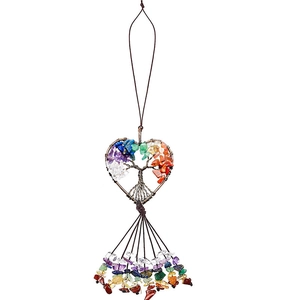 Detail of tree of life heart ornament with natural colorful crystal stones and tassels