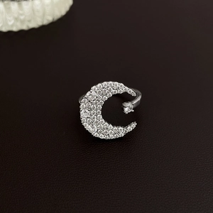 Macro shot of silver crescent moon open ring with white cubic zirconia pavé setting