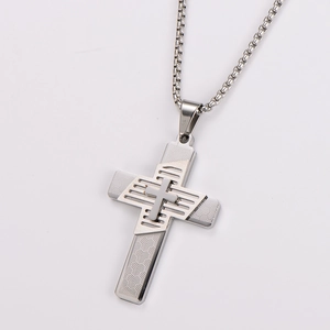 Close-up of silver stainless steel double layered cross pendant with fine texture