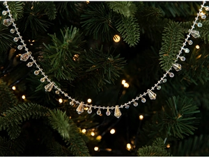 Close-up of clear acrylic crystal bead chain ornaments on a Christmas tree with warm lights