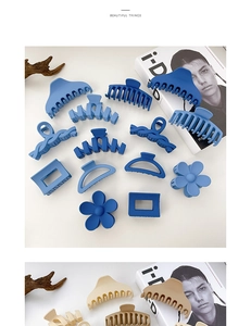 Variety of matte resin hair claws in blue and beige displayed with minimalist props