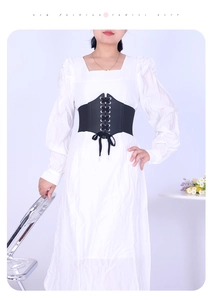 Lace-up black corset belt on white dress showing detailed PU leather texture and fit