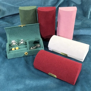 Macro view of velvet jewelry boxes in various colors with ring slots and multi-layers