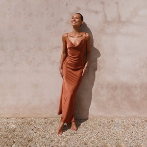 Detail of elegant caramel satin slip dress with cowl neck and sleek texture