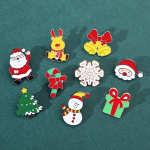 Christmas enamel brooch set with Santa, elk, and snowman designs on a green background