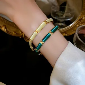 Elegant gold plated geometric bracelet with cat eye stones and minimalist links on wrist
