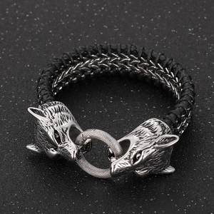 Detailed 45-degree close-up of Norse Viking style braided leather wolf head bracelet