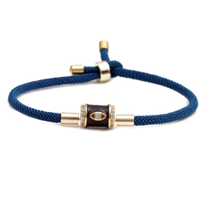 Adjustable dark blue cord bracelet with gold metal evil eye charm and clear zircon