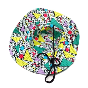 Detail of Memphis style geometric print bucket hat with adjustable black chin strap