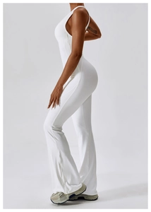 Detailed side view of white backless yoga bodysuit with flared pants design